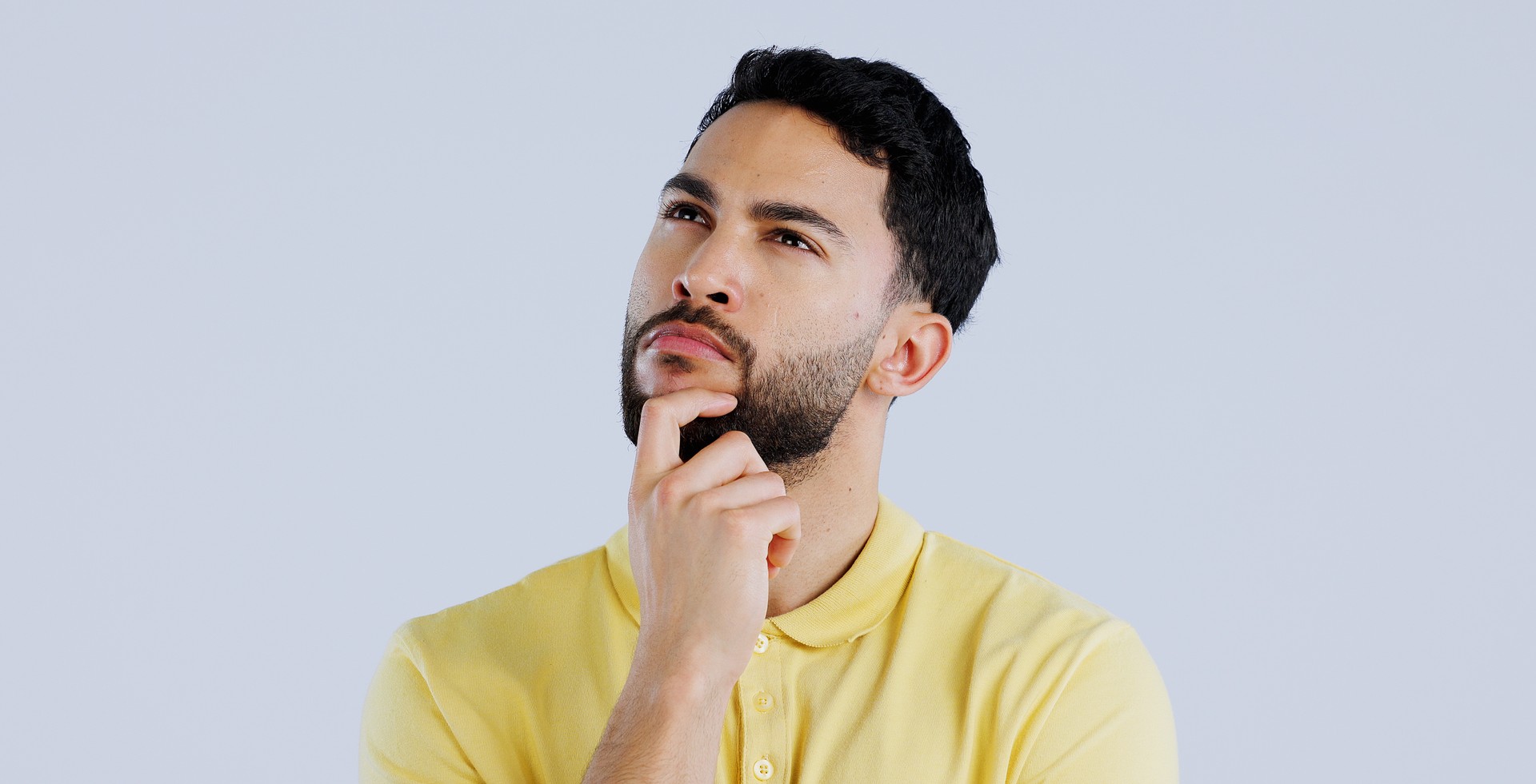 Man, confused and thinking in studio of ideas, choice and dont know why on white background. Indian model daydream of decision, remember memory or planning solution, questions and brainstorming emoji